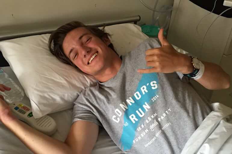 young man, smiling, in hospital bed
